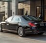 lucid origin_A_realistic_photograph_of_a_polished_black_luxury_executive_sedan_parked_outside 0 95x90